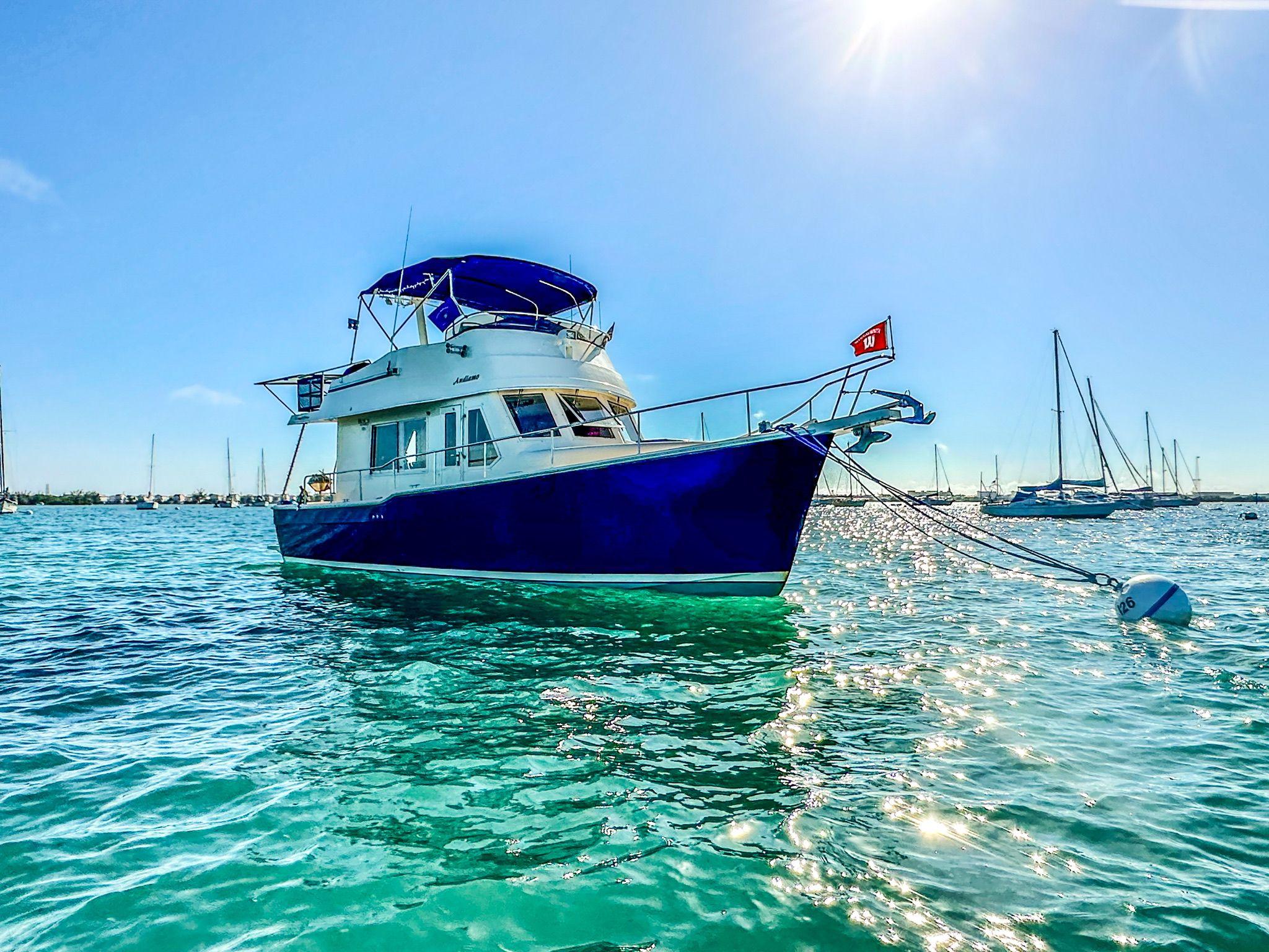 Mainship 34 Trawler 2006 Mainship 34 Trawler anchored in sunny, sparkling blue waters.