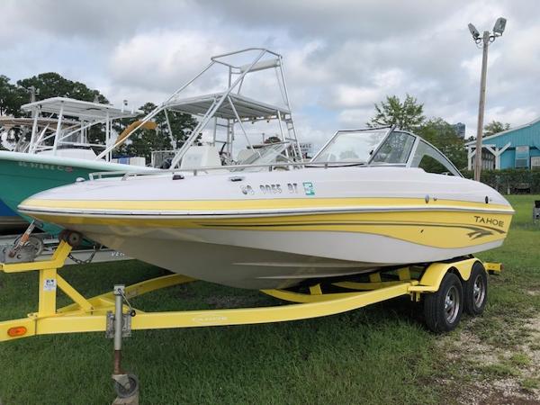 Tahoe Q4 I/O 2005 Tahoe Q4 I/O boat on a yellow trailer, parked on grass.
