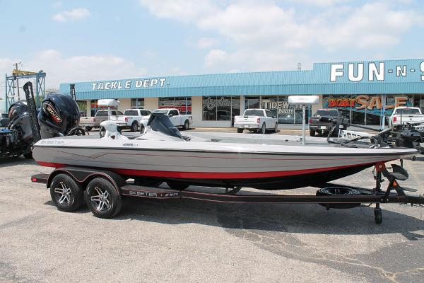 Skeeter ZXR21 2025 Skeeter ZXR21 boat on trailer in parking lot, near tackle shop.