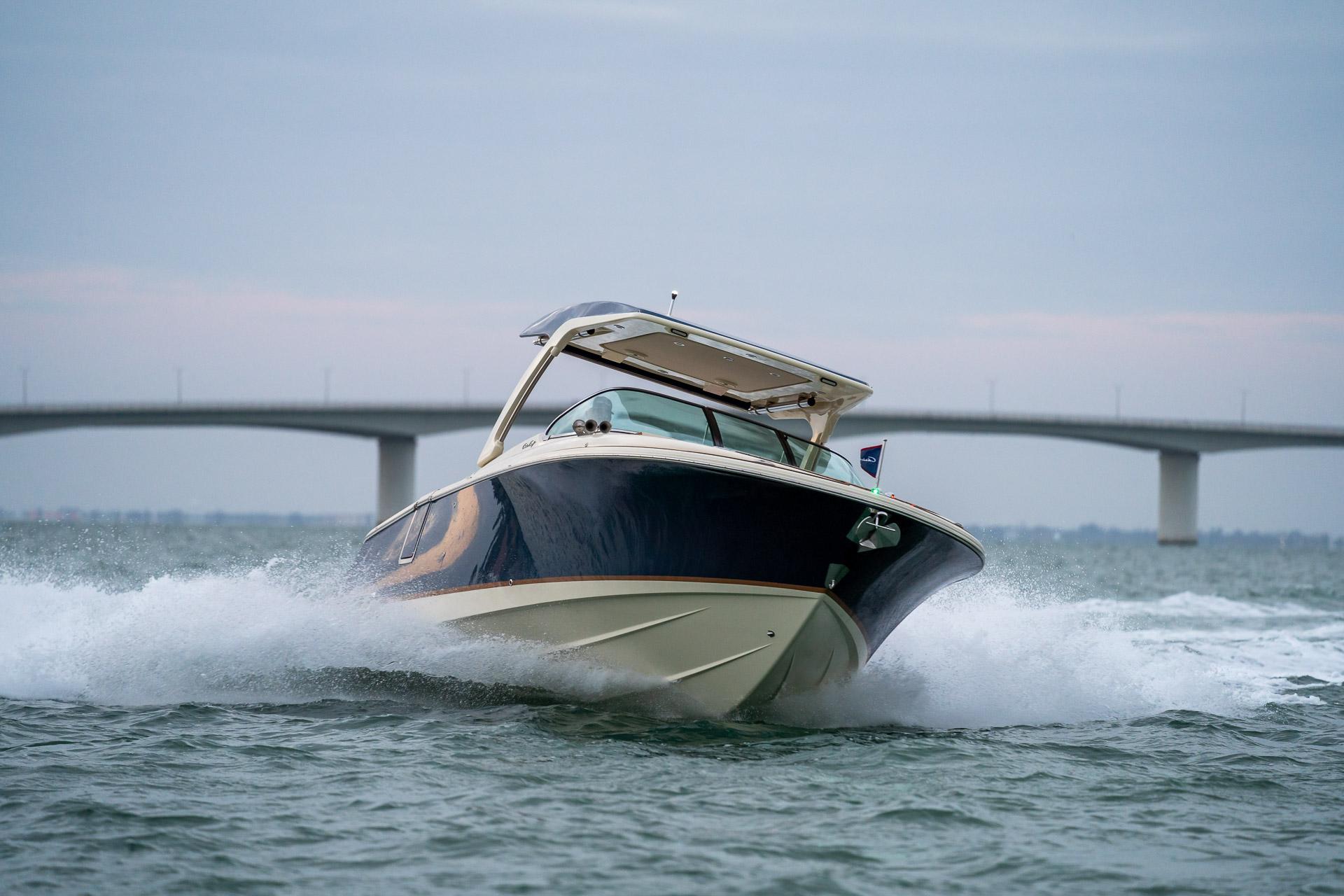 Chris-Craft Launch 31 GT 2026 Chris-Craft Launch 31 GT cruising on water with bridge in background.