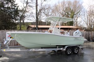 Pioneer 220 Bay Sport 2025 Pioneer 220 Bay Sport boat on trailer, parked outdoors, surrounded by trees and fence.