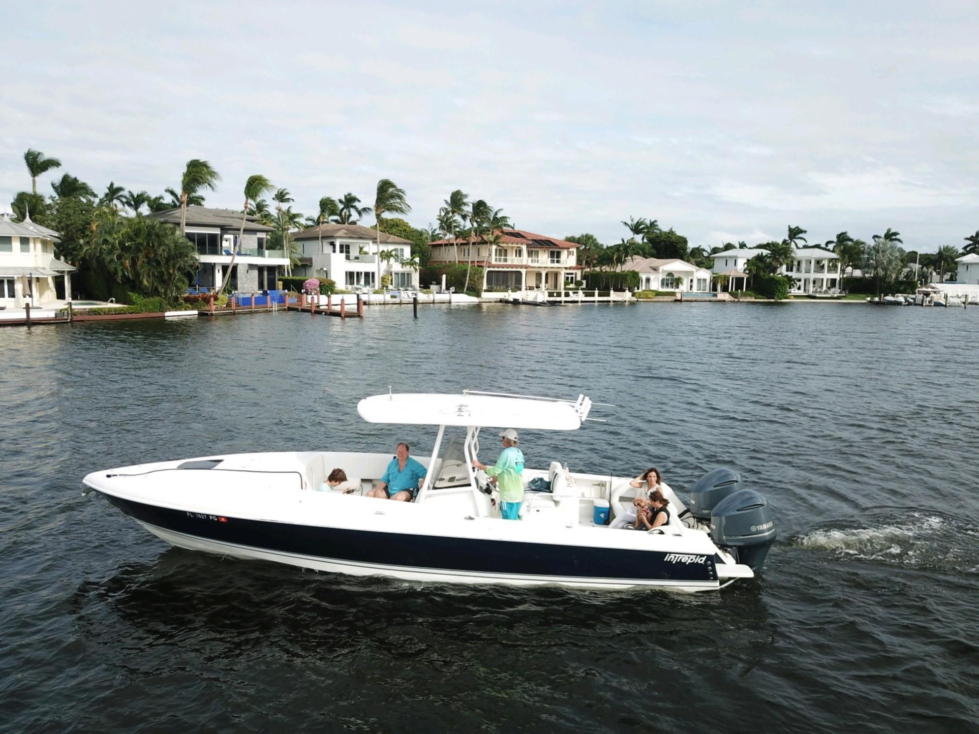 Intrepid 323 Cuddy 2005 Intrepid 323 Cuddy cruising near waterfront homes on a sunny day.