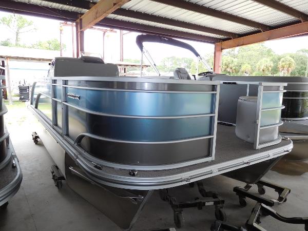 SunCatcher 20 Fish 2023 SunCatcher 20 Fish pontoon boat in a covered storage area.