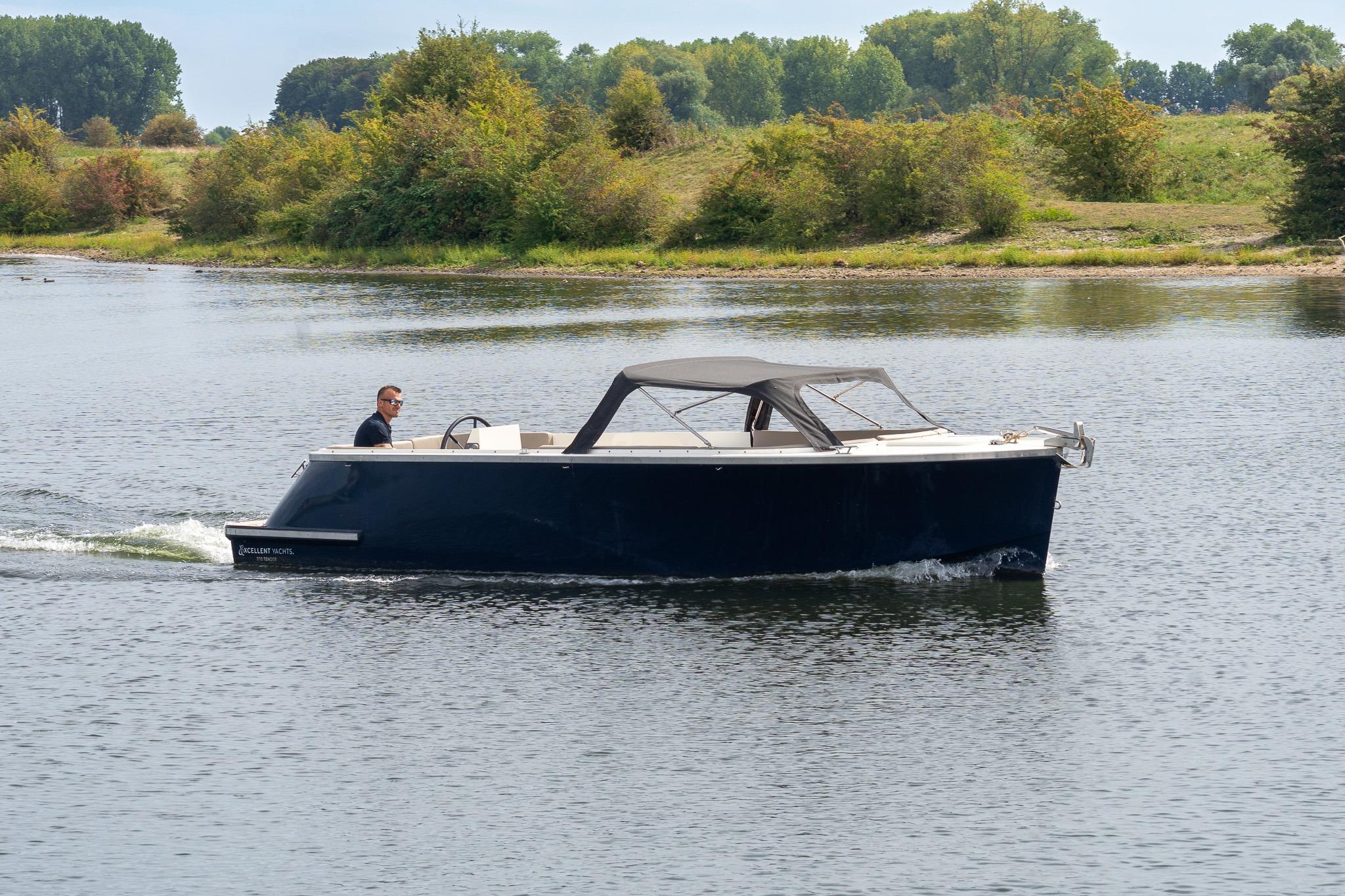 Tender Excellent 750 2021 Tender Excellent 750 boat cruising on a calm river with lush greenery.