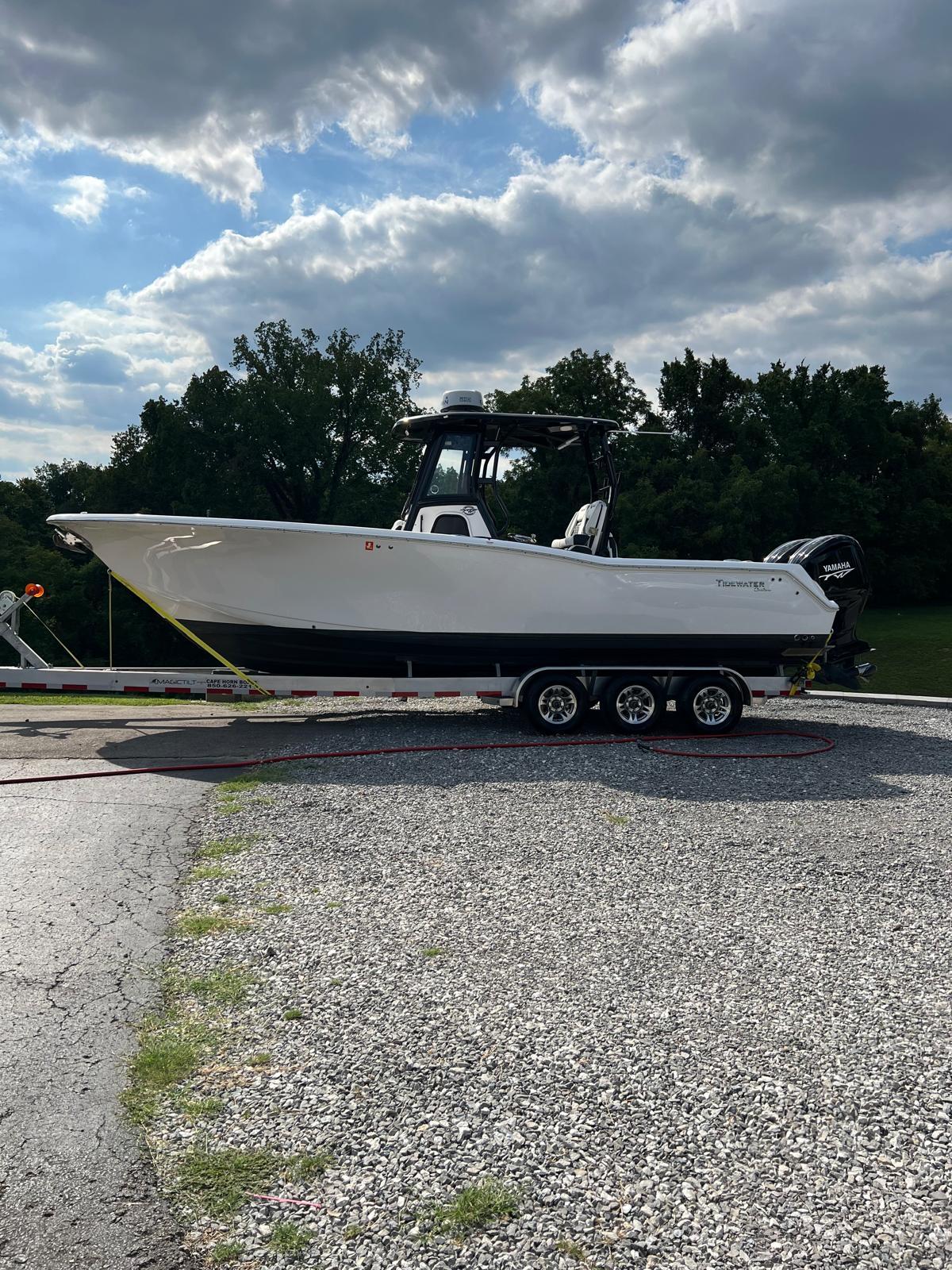 Tidewater 292 CC Adventure 2022 Tidewater 292 CC Adventure boat on trailer, parked outdoors under cloudy sky.