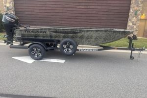 Tracker Grizzly 1650 T Prairie Wings Edition 2026 Tracker Grizzly 1650 T Prairie Wings Edition boat on trailer, parked on street.