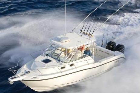 Boston Whaler 305 Conquest 2009 Boston Whaler 305 Conquest boat cruising on open water with fishing rods.