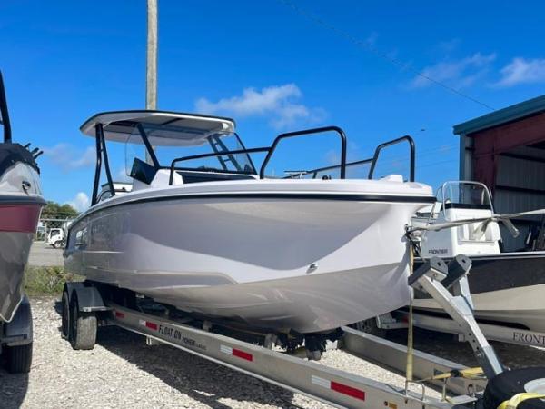 Axopar 25 Cross Top 2024 Axopar 25 Cross Top boat on a trailer under a clear blue sky.