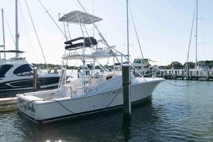 Luhrs 32 Open 1998 Luhrs 32 Open boat docked at a marina, surrounded by other vessels.