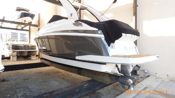 Regal 28 Express 2018 Regal 28 Express boat in storage, side view with covered deck.