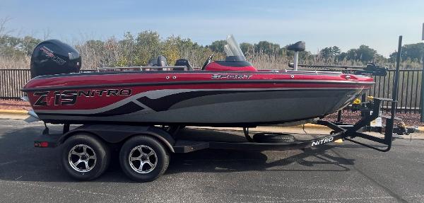 Nitro ZV19 Sport 2025 Nitro ZV19 Sport boat on trailer, red and gray design, parked outdoors.