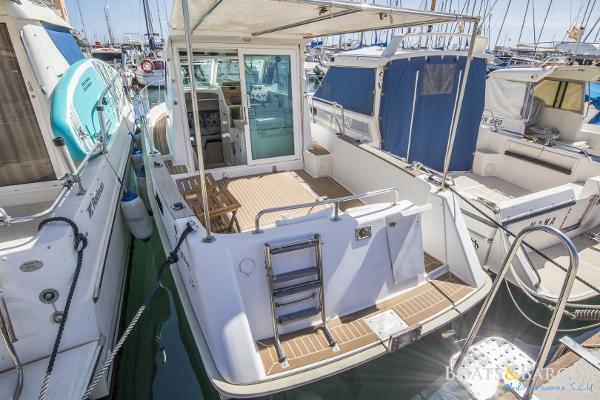 Custom Goymar 740 Custom Goymar 740 boat, 2001 model, docked in a marina with open deck and ladder.