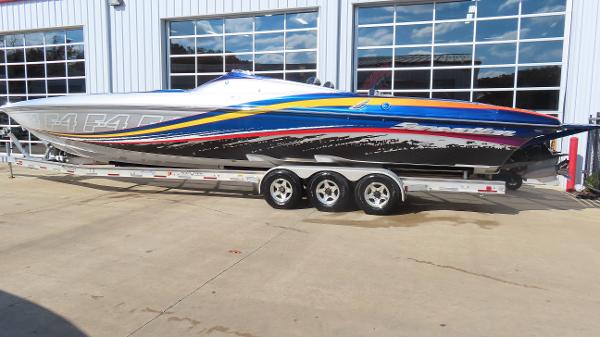 Sunsation F-4 2009 Sunsation F-4 speedboat with vibrant graphics on a trailer.