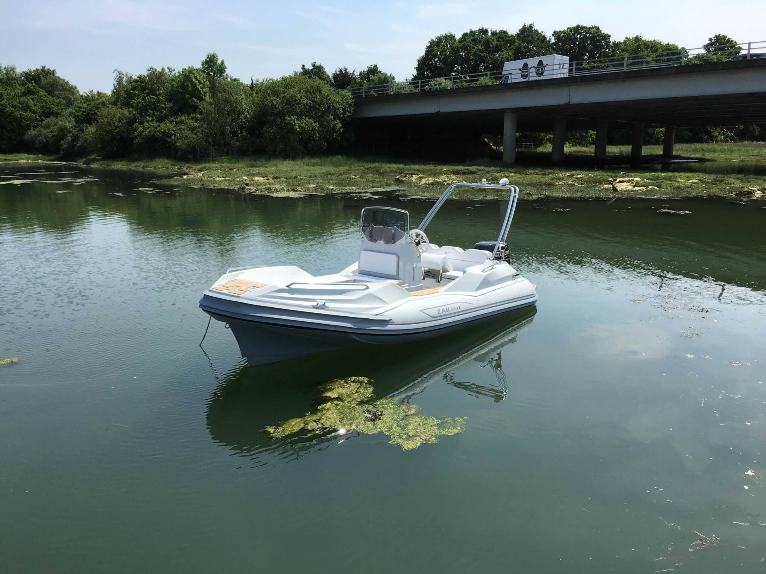 Zar Formenti ZAR Sport Luxury 2025 Zar Formenti ZAR Sport Luxury boat on calm water near a bridge.