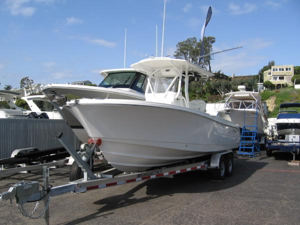 Edgewater 245CC 2023 Edgewater 245CC boat on trailer, displayed outdoors at a marina.