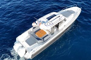 Nimbus T11 2024 Nimbus T11 boat cruising on clear blue ocean waters.