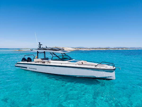Axopar 37 2025 Axopar 37 boat on clear turquoise water, under a bright blue sky.
