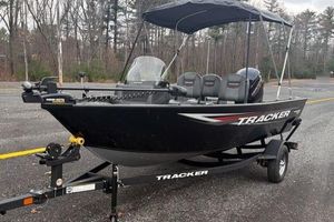 Tracker Pro Guide V-16 SC 2026 Tracker Pro Guide V-16 SC boat on trailer in parking lot.