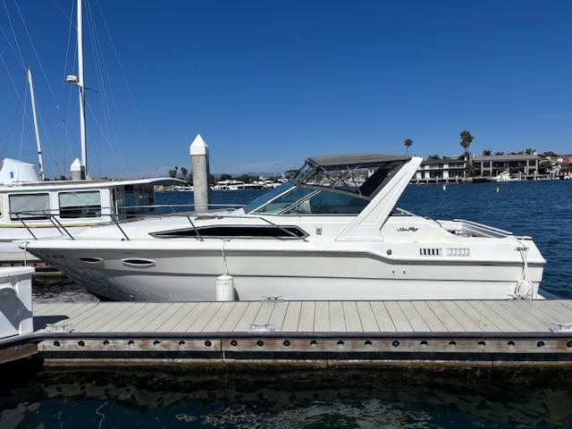 Sea Ray 300 Sundancer 1989 Sea Ray 300 Sundancer docked at marina under clear blue sky.
