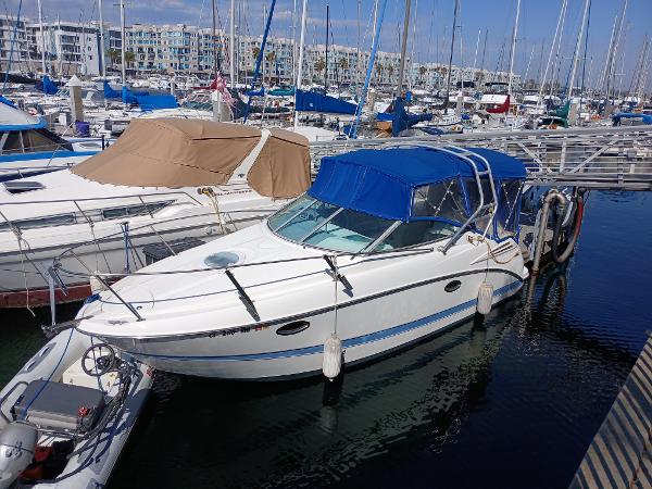 Maxum Cruiser 2006 Maxum cruiser docked in a marina with blue canopy.