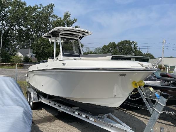 Bayliner Trophy T24CC 2023 Bayliner Trophy 24 CC boat on a trailer in a parking lot.