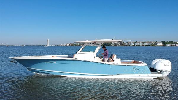 Scout 320 LXF 2015 Scout 320 LXF boat cruising on calm waters.