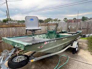 Custom Flat 16 Custom Flat 16 boat on trailer, 2016 model, parked in driveway.