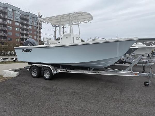 Parker 21 SE CC 2025 Parker 21 SE CC boat on trailer, parked near modern buildings.