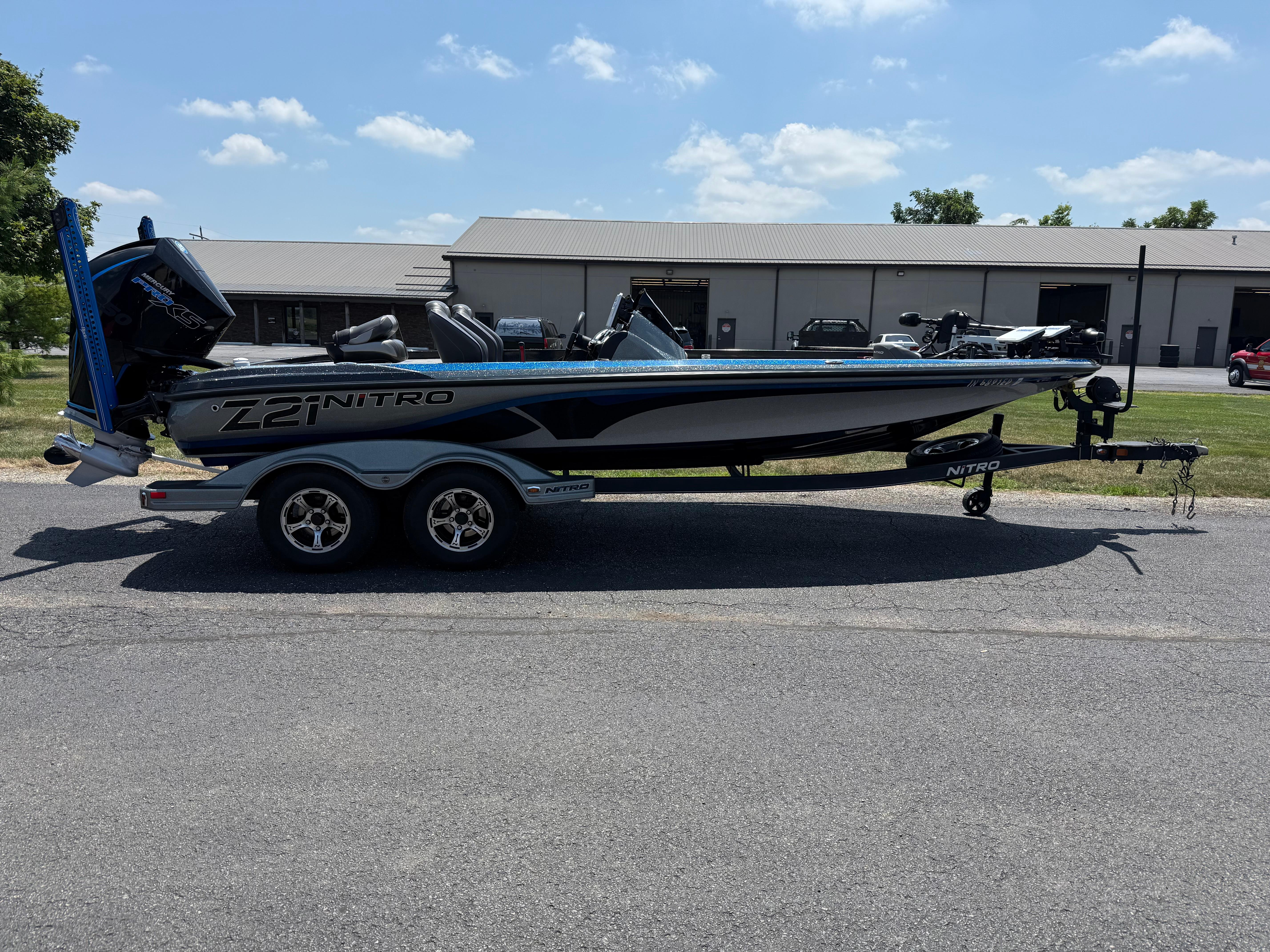 Nitro Z21 2019 Nitro Z21 boat on trailer, parked outdoors under a clear sky.