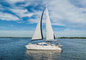 Prout 45 Sailing yacht Prout 45, 1995 model, cruising on calm waters under a clear blue sky.