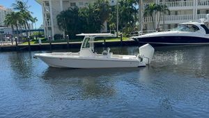 Everglades 253 Center Console 2024 Everglades 253 Center Console boat on calm water near luxury yachts.