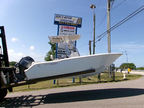 Key West 203 FS 2025 Key West 203 FS boat on forklift near Boat & Motor Superstores sign.