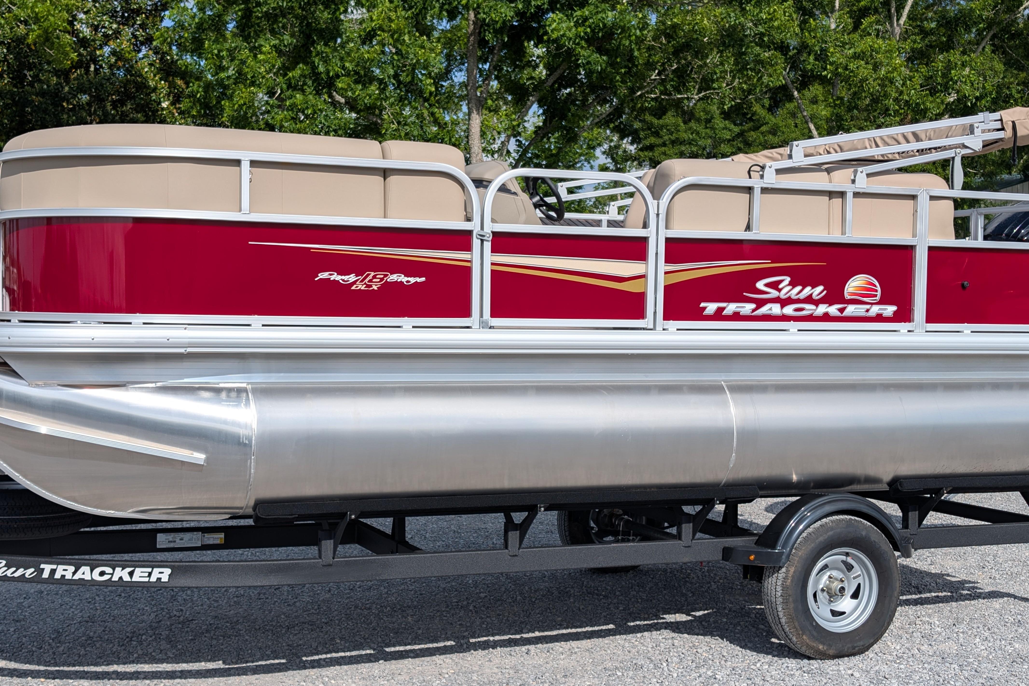 Sun Tracker Party Barge 18 DLX 2025 Sun Tracker Party Barge 18 DLX pontoon boat on trailer, red and beige design.