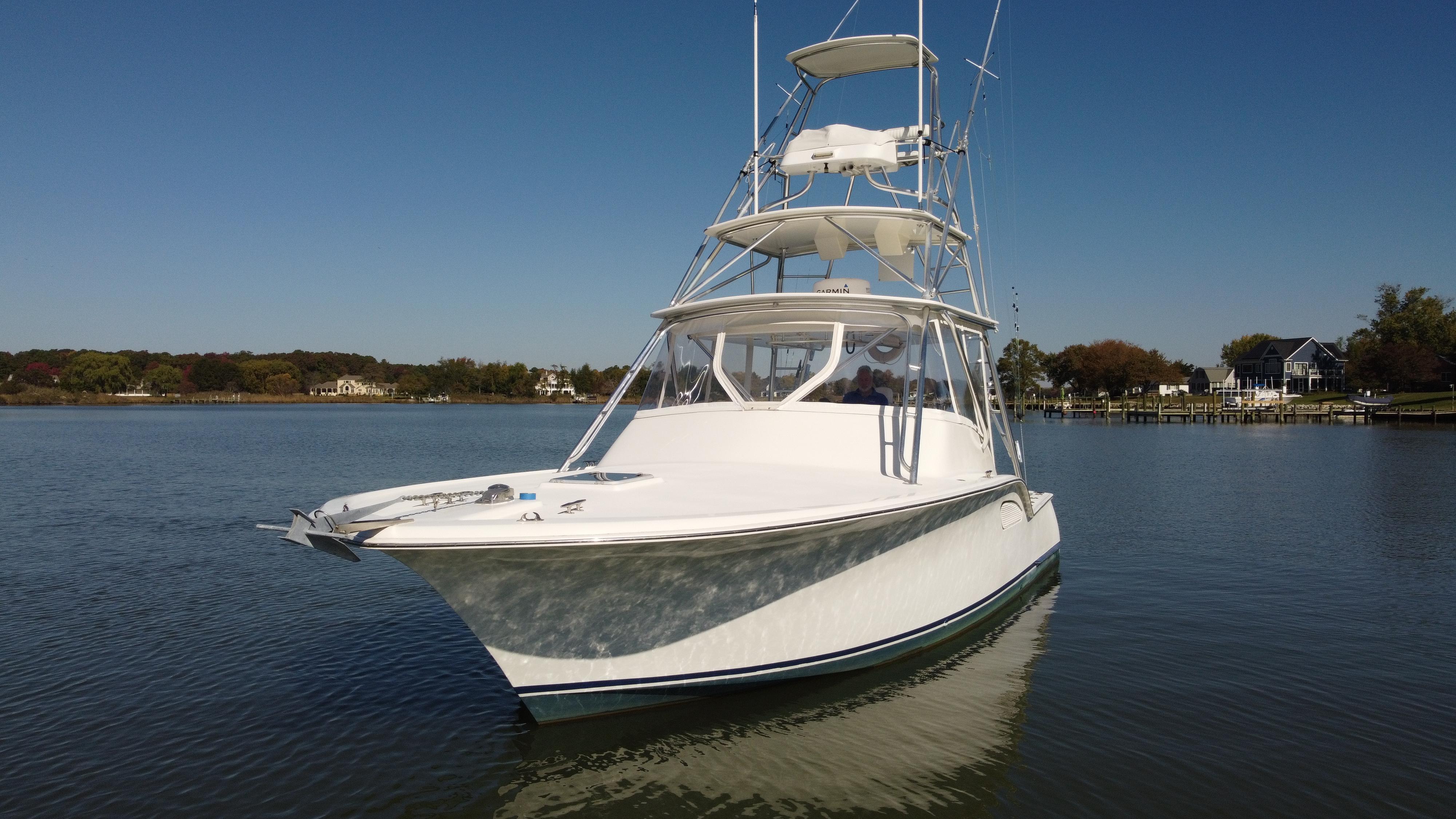 Custom SeaTek 36 Express 2008 Custom SeaTek 36 Express boat on calm water, clear sky background.