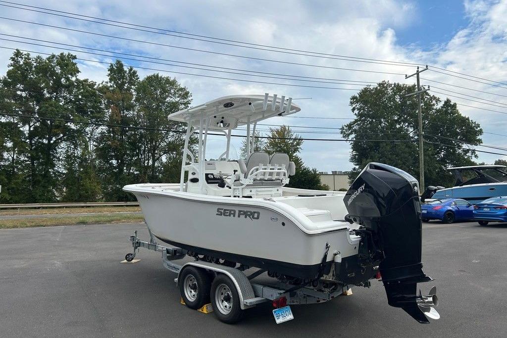 Sea Pro 219 Center Console 2019 Sea Pro 219 boat on trailer, parked outdoors under a partly cloudy sky.