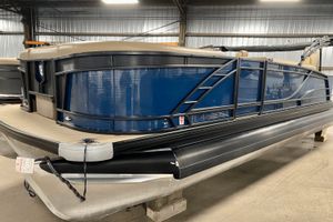 Godfrey 235 SFL 2021 Godfrey 235 SFL pontoon boat in a warehouse, featuring a sleek blue exterior.