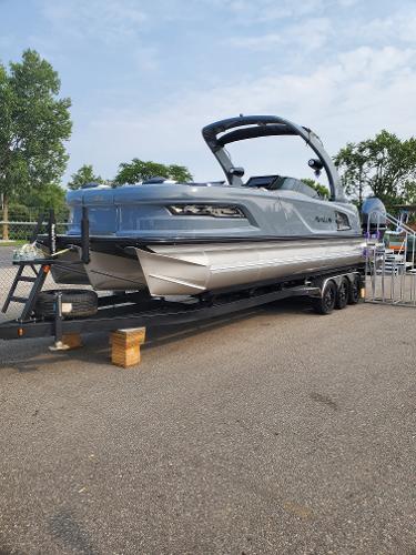 Avalon Excalibur LTD Elite Windshield 2024 Avalon Excalibur LTD Elite Windshield boat on a trailer, parked outdoors.
