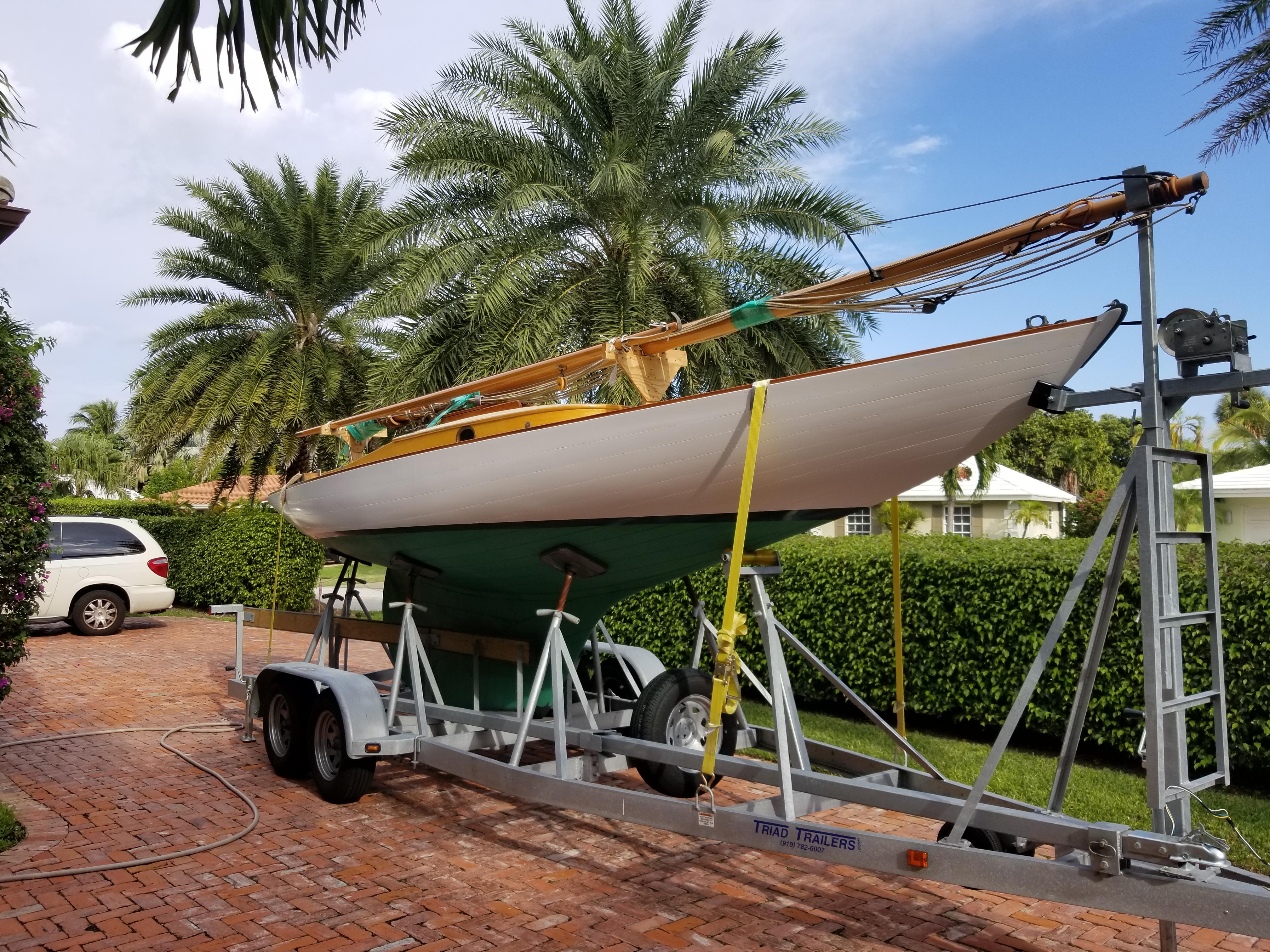 Custom Dark Harbor 17 Vintage 1930 Custom Dark Harbor 17 sailboat on trailer, surrounded by palm trees.