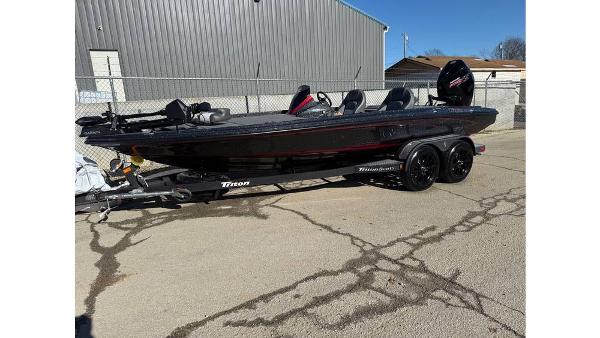 Triton 20XP Patriot 2025 Triton 20XP Patriot boat on trailer, parked outdoors.