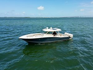 Scout 380 LXF 2021 Scout 380 LXF boat cruising on open water under clear skies.