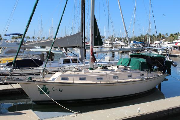 Island Packet 40 1994 Island Packet 40 sailboat docked in a marina, surrounded by other boats.