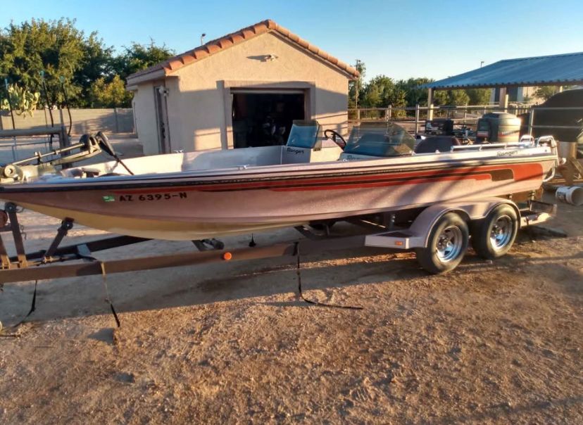 Ranger 392V 1983 Ranger 392V boat on trailer, parked outdoors near a garage.