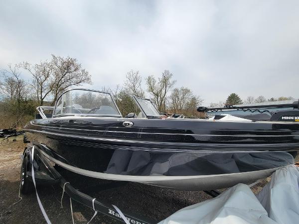 Ranger 1850 Reata 2024 Ranger 1850 Reata boat, sleek black design, parked outdoors on a trailer.