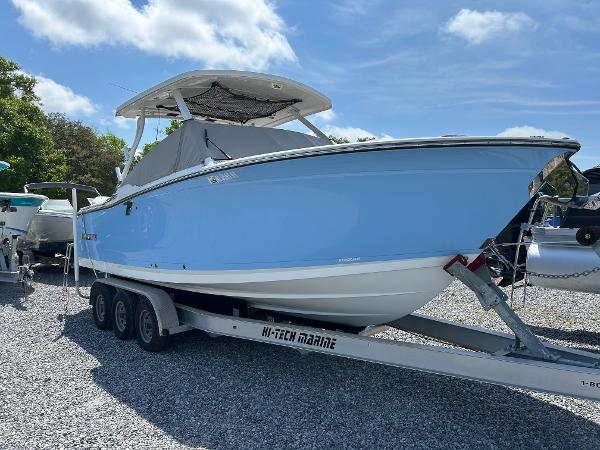 Blackfin 272 DC 2023 Blackfin 272 DC boat on trailer, light blue hull, parked outdoors.