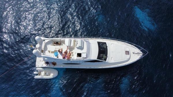 Ferretti Yachts 550 Aerial view of 2006 Ferretti Yachts 550 cruising on deep blue ocean waters.