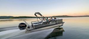 SunCatcher Select 322SS 2024 SunCatcher Select 322SS pontoon boat cruising on a serene lake at sunset.