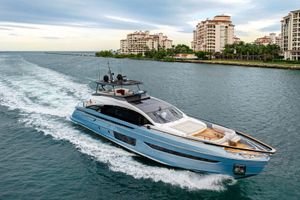 Azimut S10 2022 Azimut S10 yacht cruising near luxury waterfront buildings.