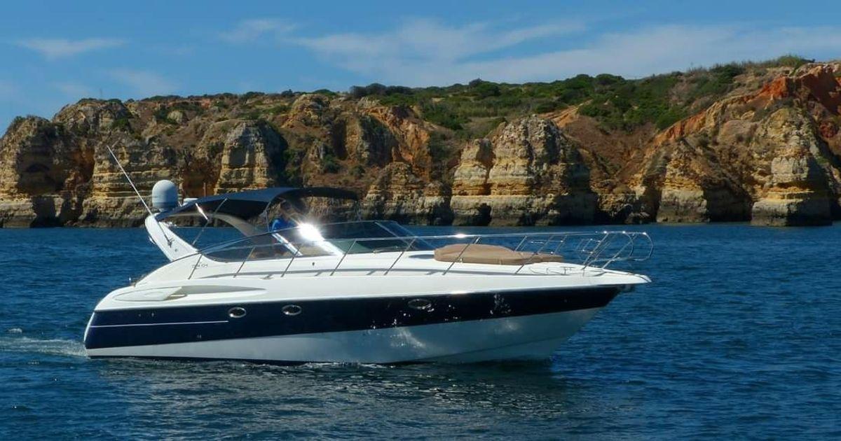 Cranchi Endurance 39 2001 Cranchi Endurance 39 yacht cruising near rocky cliffs.