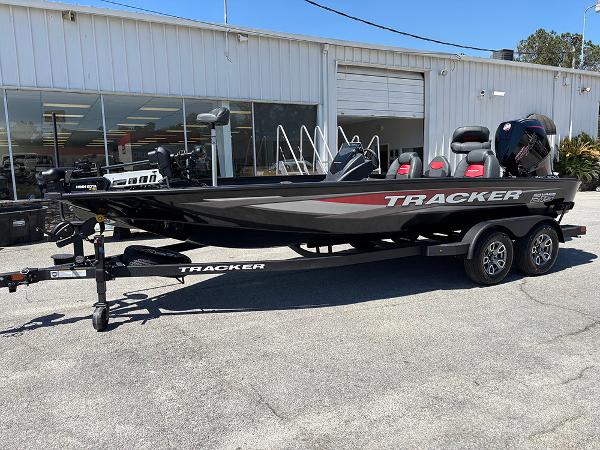 Tracker Savage 215 2025 Tracker Savage 215 boat on trailer outside dealership.