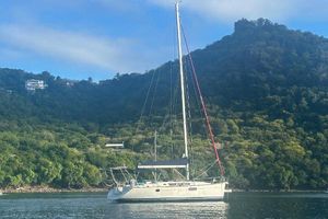 Jeanneau Sun Odyssey 44i Jeanneau Sun Odyssey 44i sailboat anchored near lush green hillside, 2010 model.